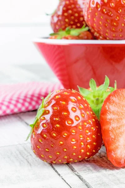 Fresh Strawberries on a table and in a bowl — Stock Photo, Image