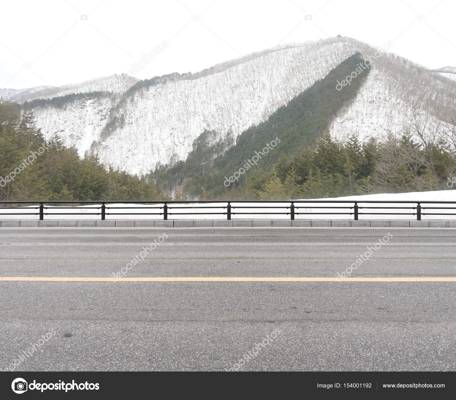 Country Road Side View at snow mountain background. Stock Photo by ©Kris  154001192