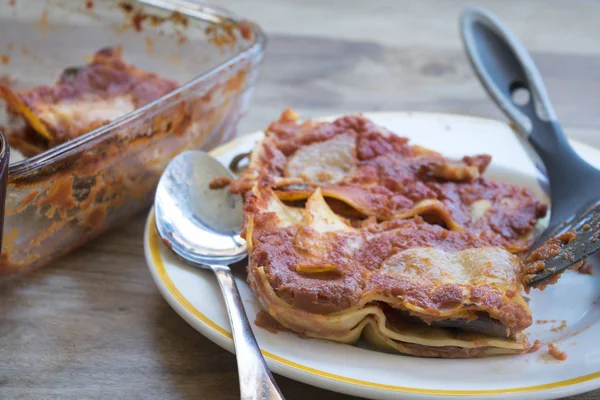 Portion of lasagna just taken by the baking-pan — Stock Photo, Image