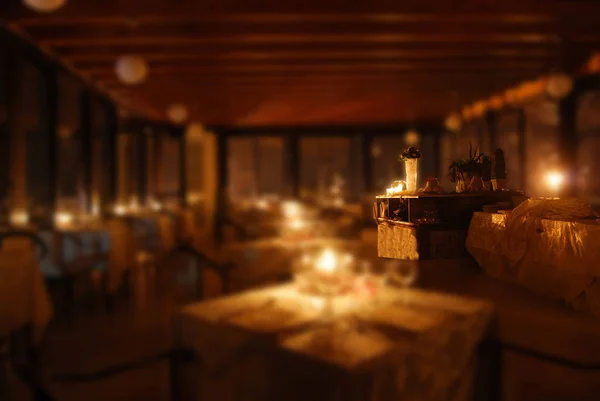 Set tables of a restaurant by candlelight — Stock Photo, Image