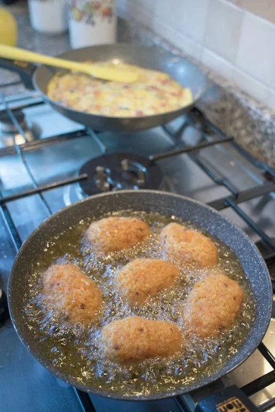 Rice croquettes frying in boiling oil — Stock Photo, Image