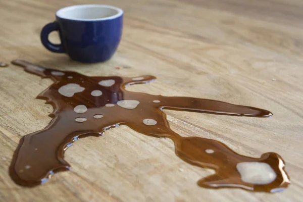 Espresso coffee spilled on a wooden table — Stock Photo, Image