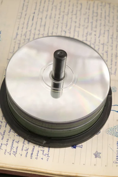 Pile of compact disk on an old diary — Stock Photo, Image