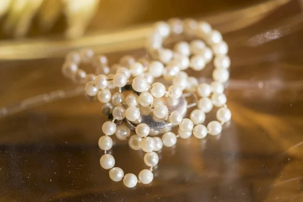 Pearl necklace laid on a wooden plane — Stock Photo, Image