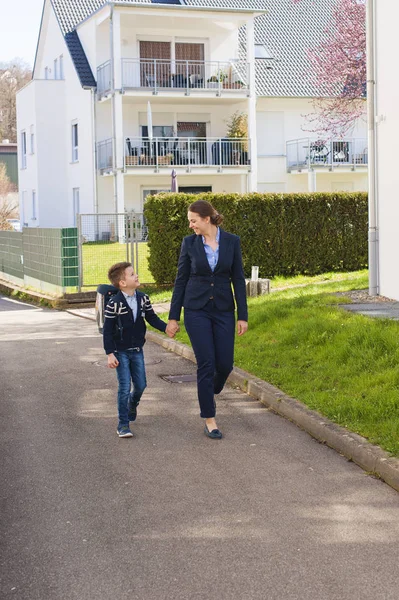 Lycklig mor och son gå till skolan. — Stockfoto