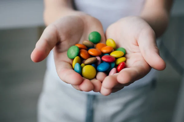 A child holding a handful of candy — Stock Photo, Image