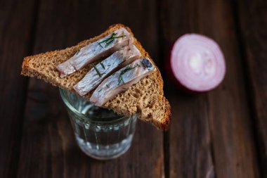 Sandwich with herring and vodka clipart