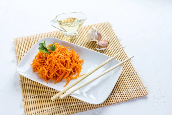 Korean carrots on white wooden table