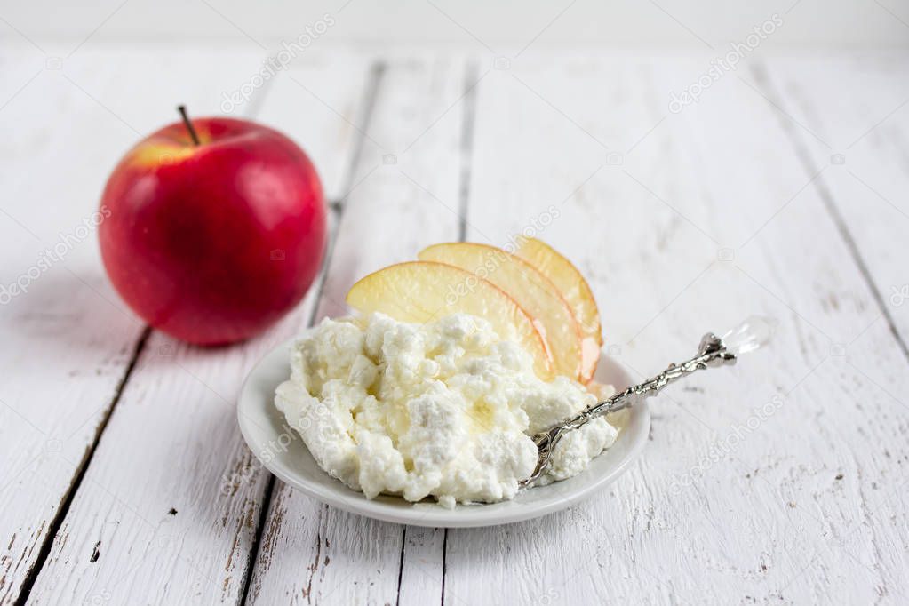 Cottage cheese, honey and Apple on a plate