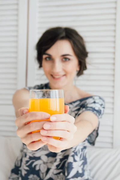Девушка пьет апельсиновый сок на завтрак в постель — стоковое фото