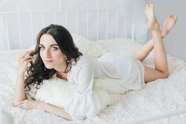 Beautiful young woman in white negligee in the morning — Stock Photo, Image