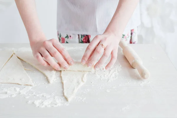 Young beautiful woman preparing homemade croissants — Stock Photo, Image