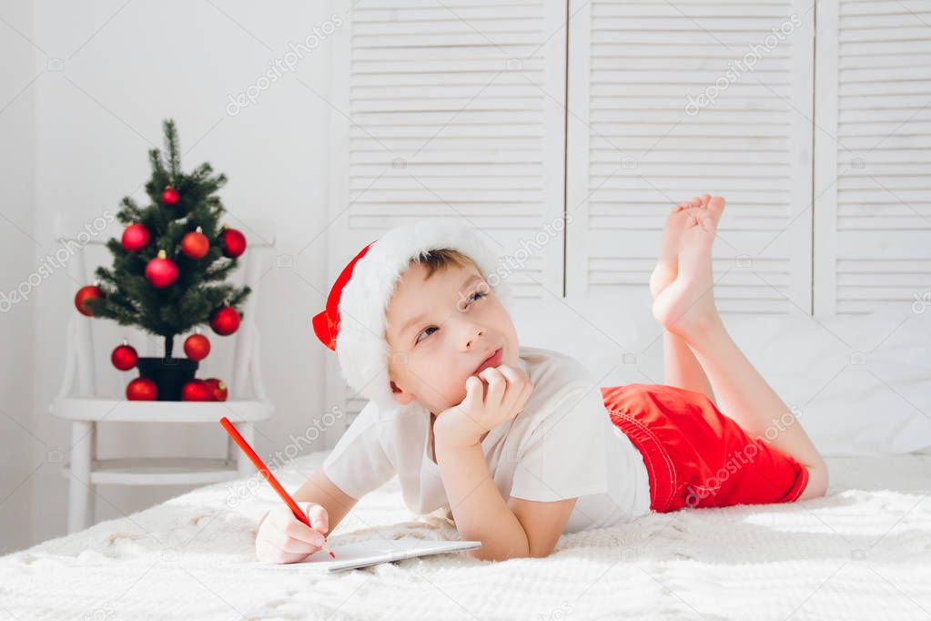 Boy thinks that he would write the letter to Santa