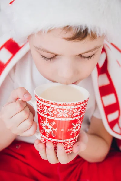 Boy drink cocoa in a mug — Stock Photo, Image
