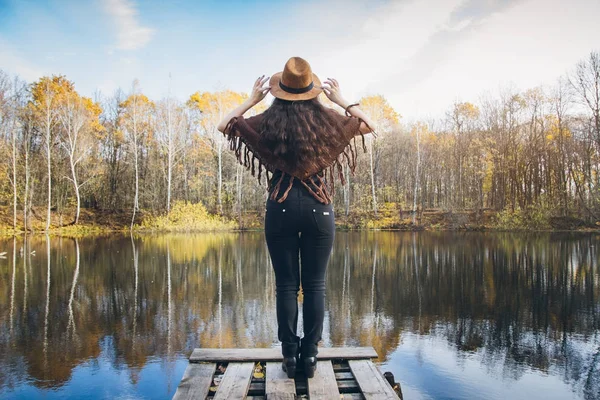 Girl on a wooden old bridge on a lake — Stock Photo, Image