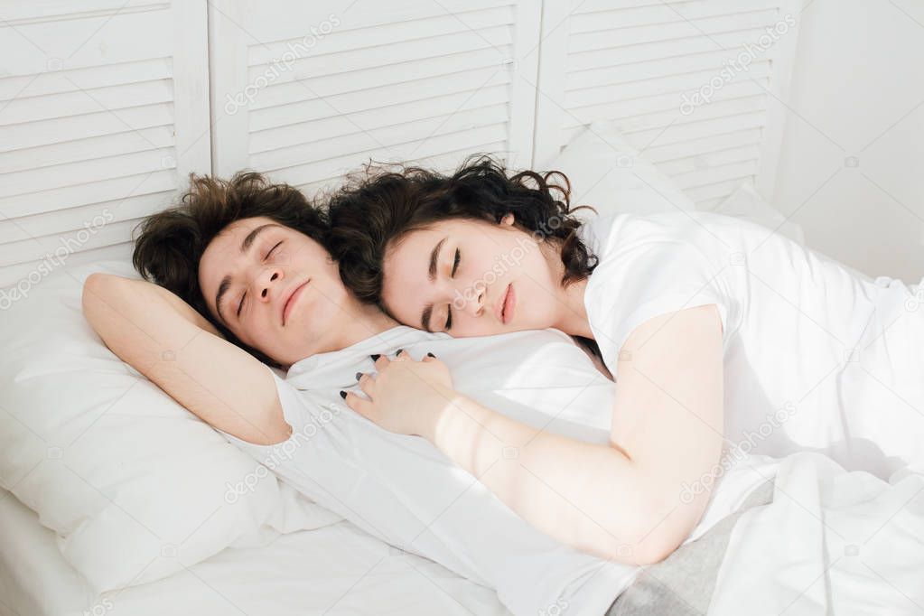 Couple in love sleeps cuddling in bed 