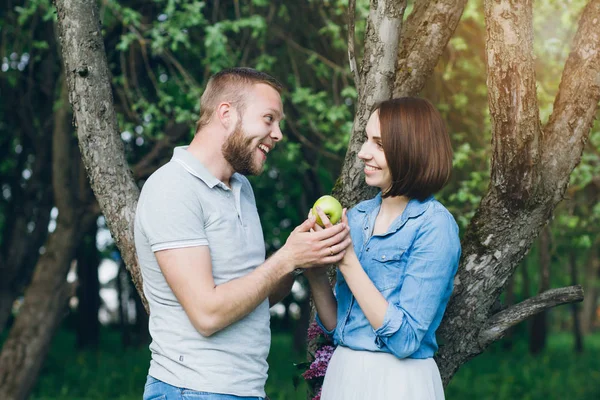 La pareja enamorada descansan en verano El huerto de manzana —  Fotos de Stock