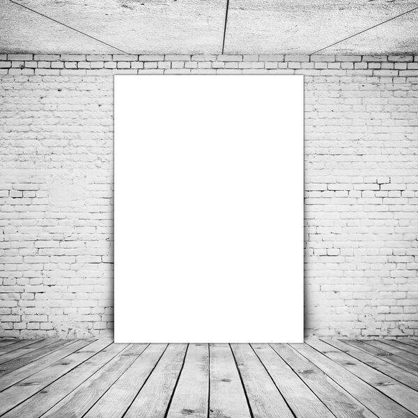 Empty poster (210*297) in old interior with brick wall and wood floor