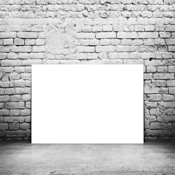 Empty poster (210*297) in old interior with brick wall and wood floor — Stock Photo, Image