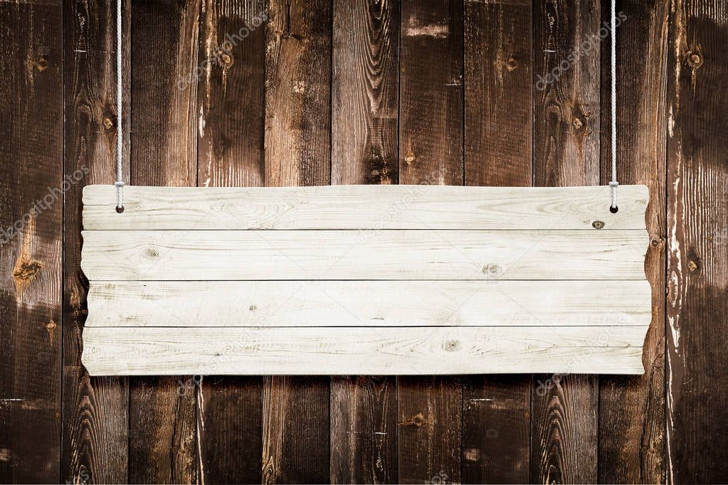 Wooden sign with ropes isolated over planks background