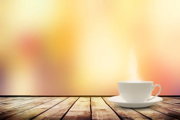 Cup with tea on table over blur bokeh nature background — Stock Photo, Image
