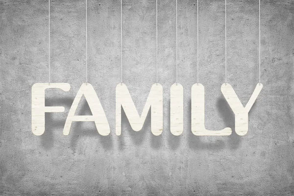 Trä ordet ”familj” med rep över vit vägg bakgrund — Stockfoto