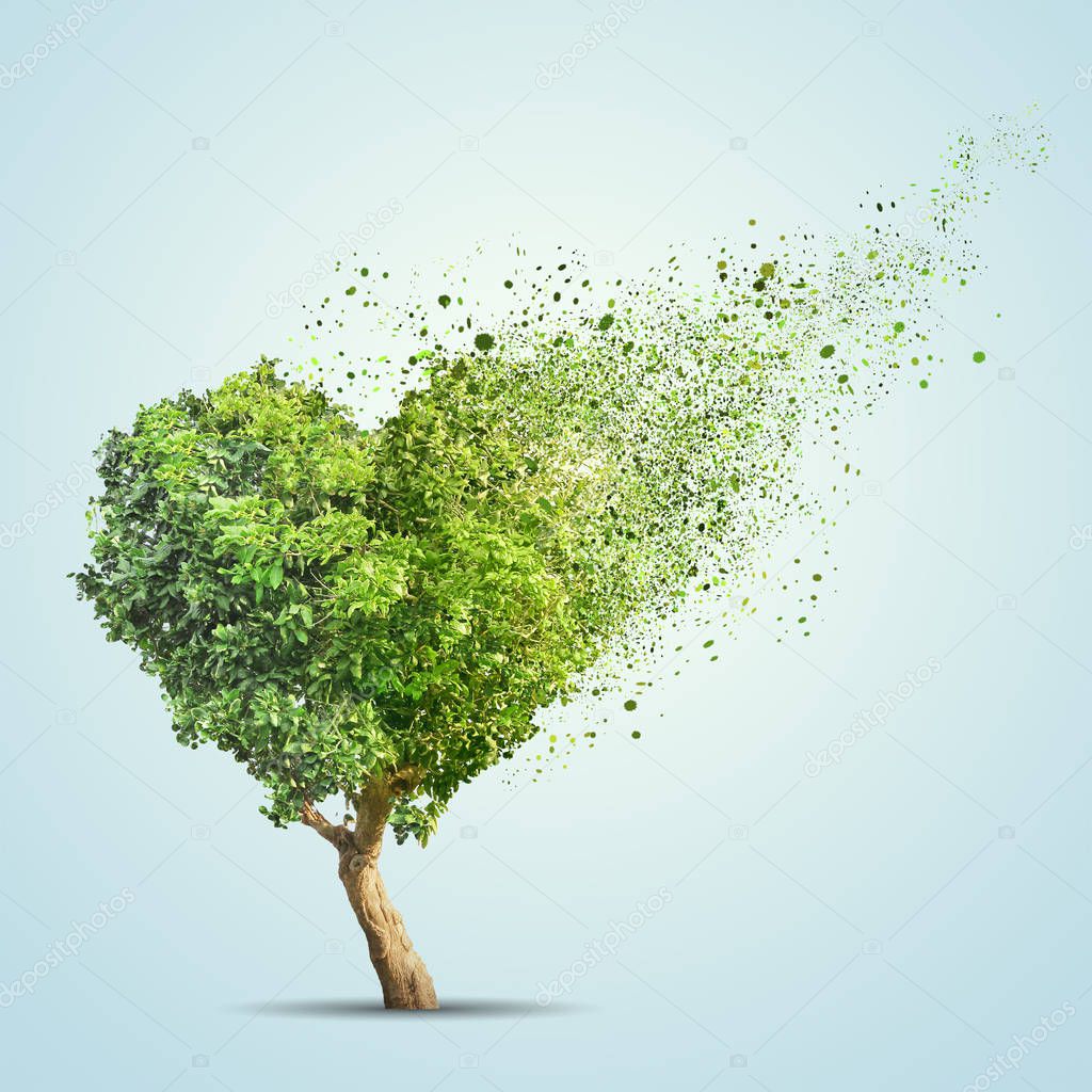 Green tree shaped in heart disintegrate over blue background