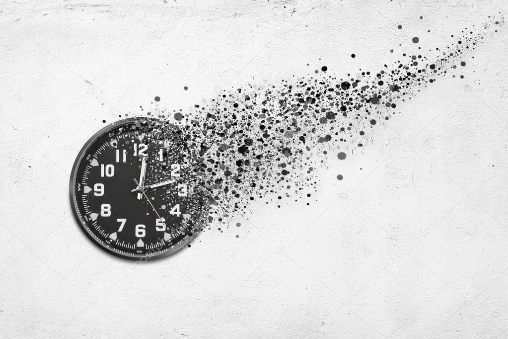 Classic clock on white concrete background disintegrate in a small parts and flying away. Time flying concept