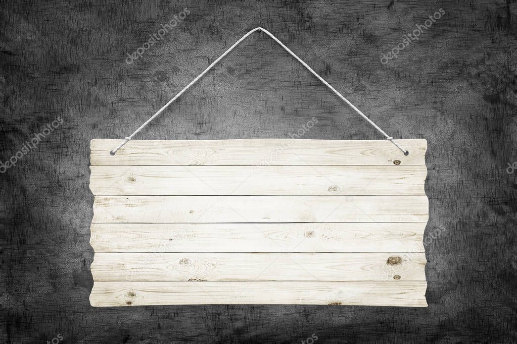 Wooden sign with ropes over dark grunge wall background