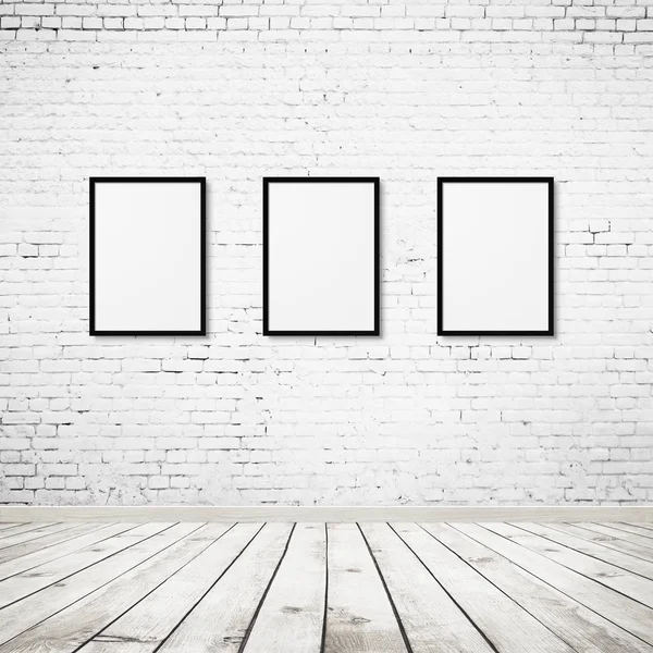 Vintage room interior with three photo frames over white brick wall and wood floor background — Stock Photo, Image
