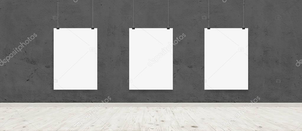 Tree white blank posters with binders in interior with concrete wall and wooden floor