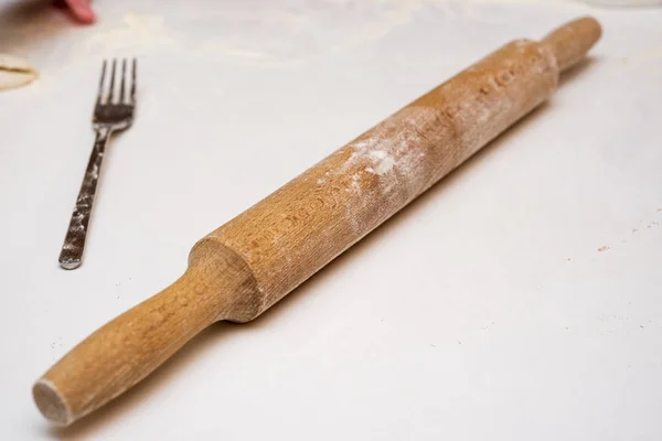 rolling pin on the table with flour