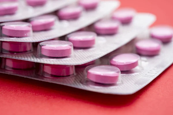 Stack Pink Pills Blister Packs Red Background Close — Stock Photo, Image