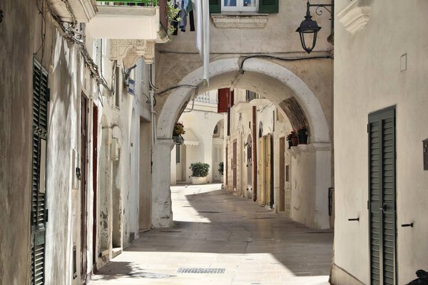 Monopoli town in Apulia region, Italy. Old town street archway.