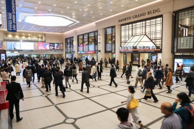 OSAKA, JAPAN - NOVEMBER 22, 2016: Passengers hurry at Hankyu Umeda Station in Osaka, Japan. Hankyu Umeda Station opened in 1910 and is operated by Hankyu Corporation. clipart