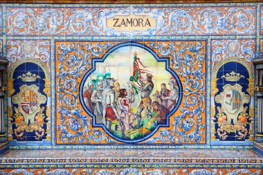 SEVILLE, SPAIN - NOVEMBER 3, 2012: Zamora azulejos theme detail of famous Plaza de Espana in Seville. The Renaissance revival and art deco styles landmark was completed in 1928. clipart