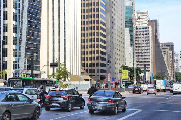 SAO PAULO, BRAZIL - OCTOBER 6, 2014: Cars drive at Avenida Paulista avenue, Sao Paulo. With 21.2 million people Sao Paulo metropolitan area is the 8th most populous in the world.