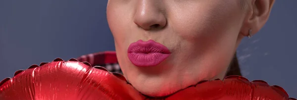woman\'s lips to blow kisse