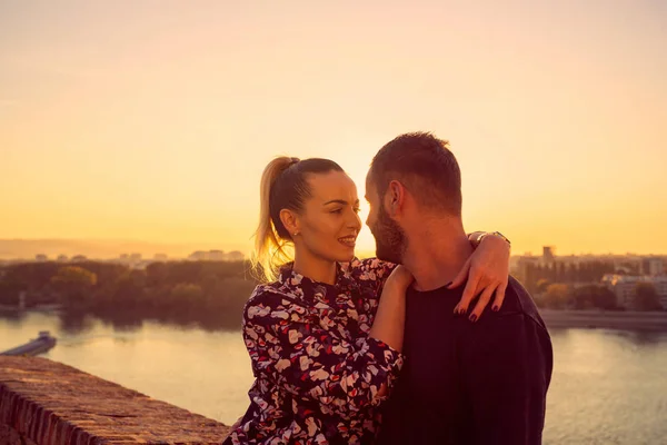 romantic couple at sunset. Man and woman is enjoying sunset in t
