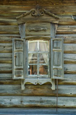 Eski Rus şehrin eski ahşap evde Ahşap oyma arşitrav penceresiyle.