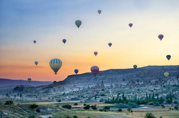Balão de ar quente sobrevoando a paisagem rochosa na Capadócia Turquia — Fotografia de Stock