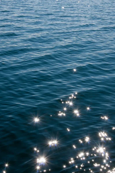 Pırıltı ve göl su yansıtan güneş ışığı. Arka plan ile yıldız efekti — Stok fotoğraf