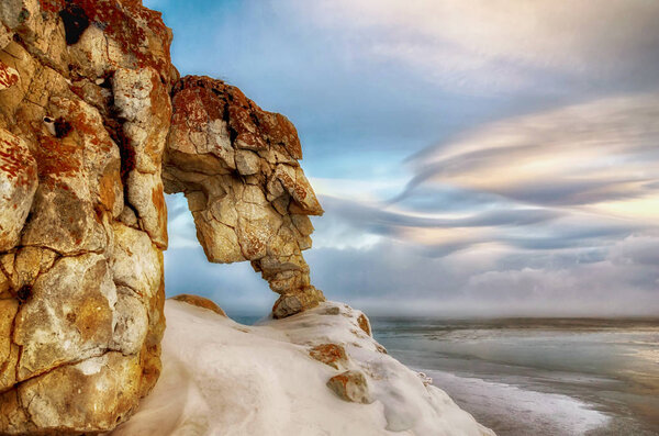Field of ice hummocks and rock on the frozen Lake Baikal. Sunset
