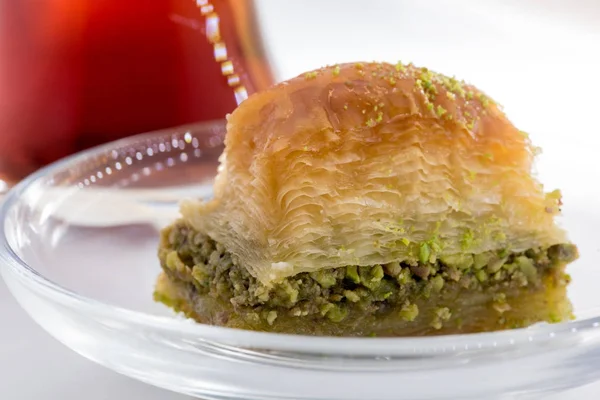 Baklava with pistachio and turkish cup of tea on a white background — Stock Photo, Image