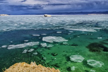 View above big beautiful lake Baikal with Ice floes floating on the water, Russia clipart