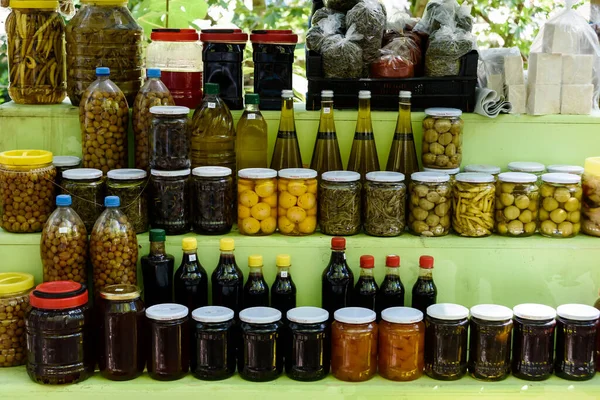 Jars with pickles, green tomatoes, cayenne pepper, mixed salad and chillies, olives — Stock Image Jars with pickles, green tomatoes, cayenne pepper, mixed salad and chillies, olives Stock Image