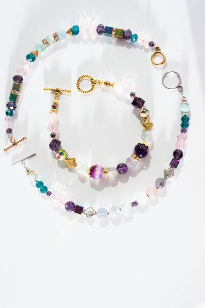 Gold jewelry bracelets with semiprecious and crystal at white ba — ストック写真
