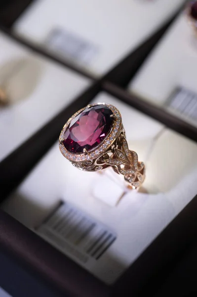 jewelry retail store showcase displaying white gold ring  with precious  gemstones. ring with huge ruby and diamonds. close up