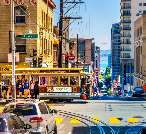 ซานฟรานซิสโก 22 กันยายน 2015: รถเคเบิ้ลในใจกลางของซานฟรานซิสโกกับนักท่องเที่ยวจํานวนมากในวันฤดูร้อนที่มีสีสัน รถเคเบิ้ลของ Powell-Hyde-Line ที่แยกของ Powell Washington Street . — ภาพถ่ายสต็อก