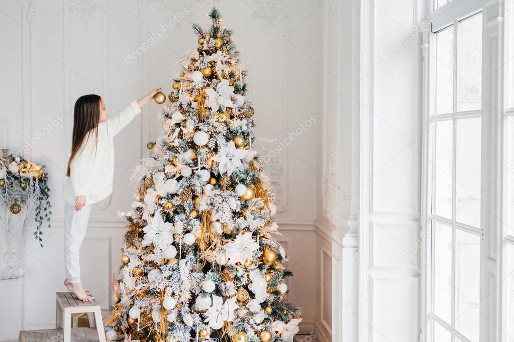 Girl decorating Christmas tree